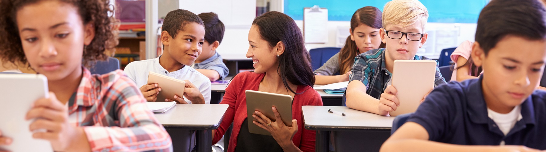 student sitting in their desks in a classroom studying