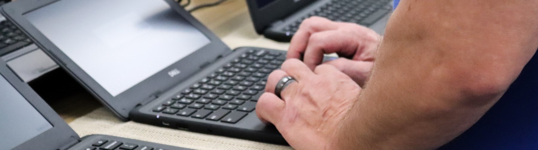 man typing on a laptop