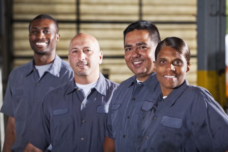 Team of mechanics in dark gray uniforms