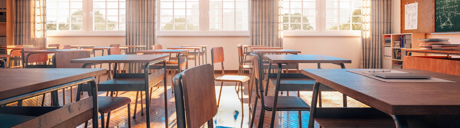 empty classroom with rows of desks and chairs