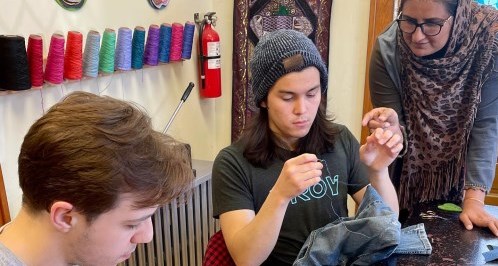 students learning how to sew