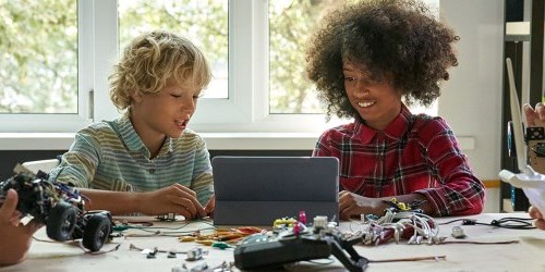 students building robotics using a tablet