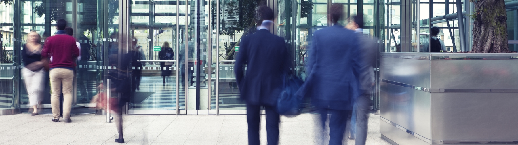 People walking towards and away from a building
