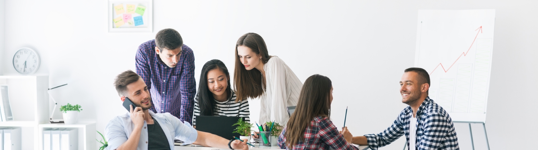 Students talking and working around a desk